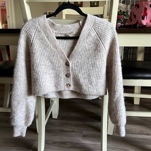 Comfortable & cute crop topped sweater with three buttons.